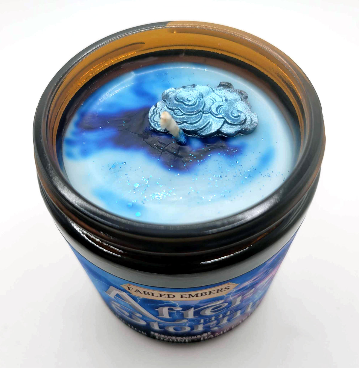 AFTER THE STORM candle with cloud and color swirl decoration.